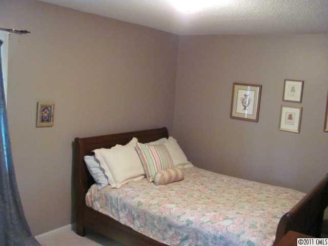 3800 Churchill Road, Unit 1 Charlotte, NC 28211 - Photo 14 of 16 a bedroom with a bed and painting on the wall