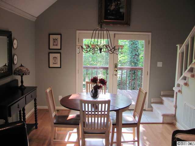 3800 Churchill Road, Unit 1 Charlotte, NC 28211 - Photo 4 of 16 a dining room with furniture a rug and wooden floor