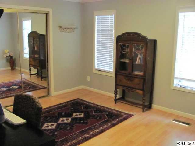 3800 Churchill Road, Unit 1 Charlotte, NC 28211 - Photo 7 of 16 a room that has a bed and a chair in it