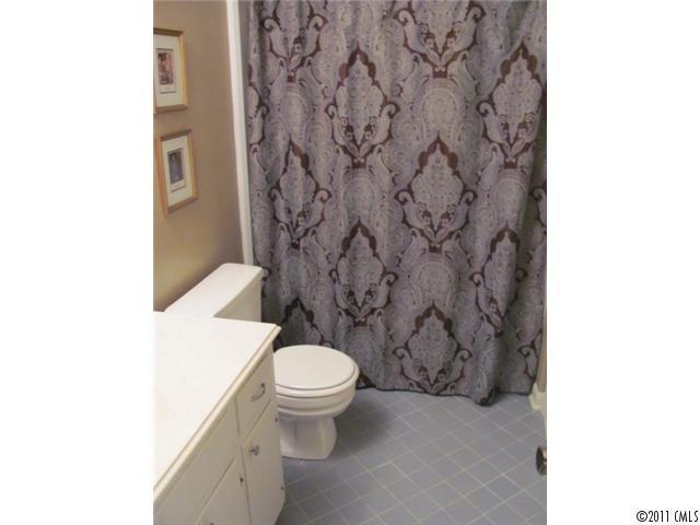 3800 Churchill Road, Unit 1 Charlotte, NC 28211 - Photo 9 of 16 a white toilet sitting next to a shower curtain