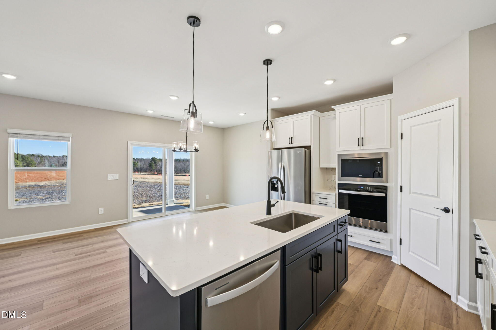 3516 Telluride Trail Raleigh, NC 27616 - Photo 2 of 47 a kitchen with stainless steel appliances kitchen island granite countertop a sink a stove a refrigerator and island with wooden floor