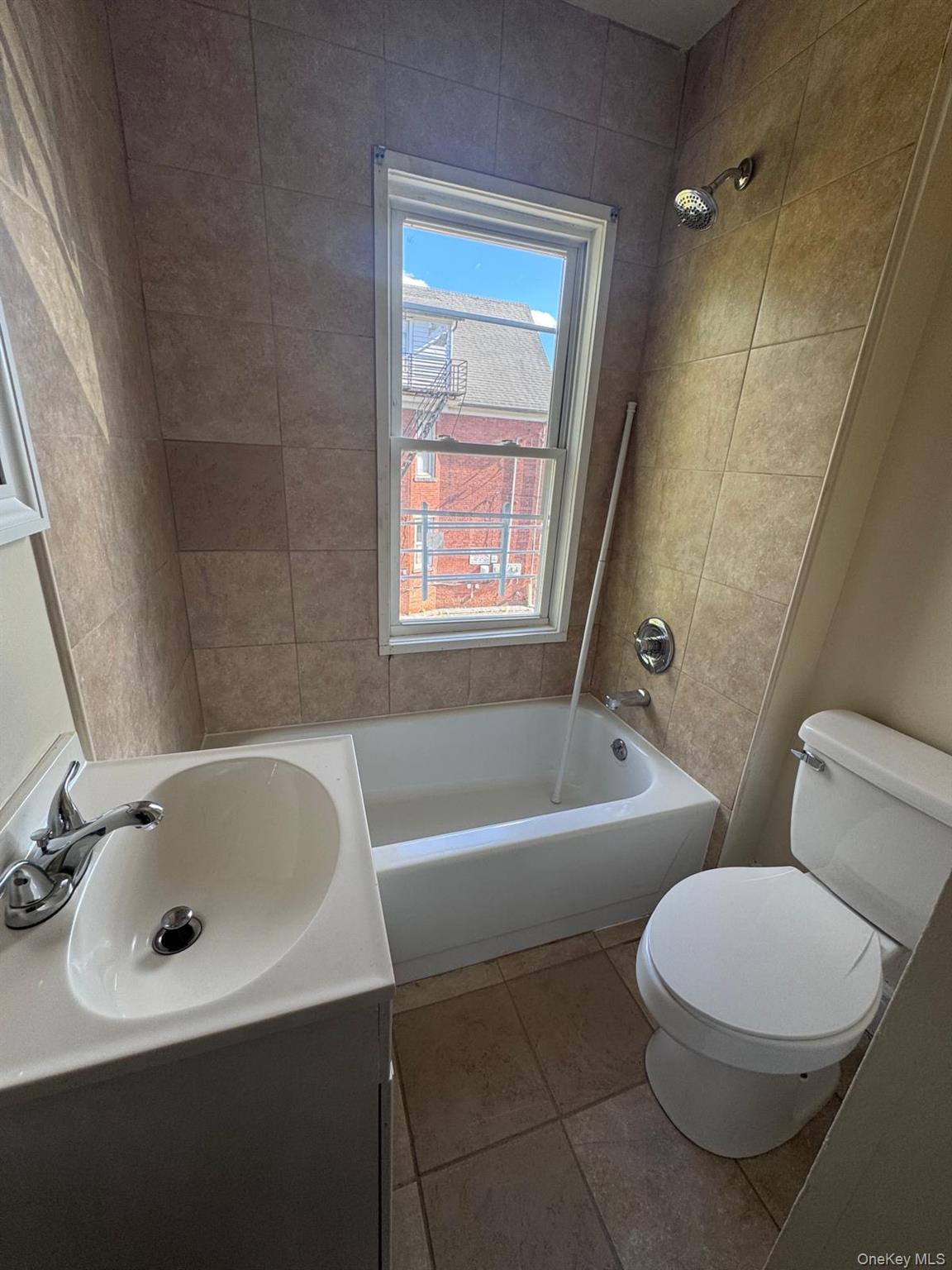 25 Lent Street, Unit 2 Poughkeepsie, NY 12601 - Photo 11 of 14 a bathroom with a sink a toilet and a bathtub