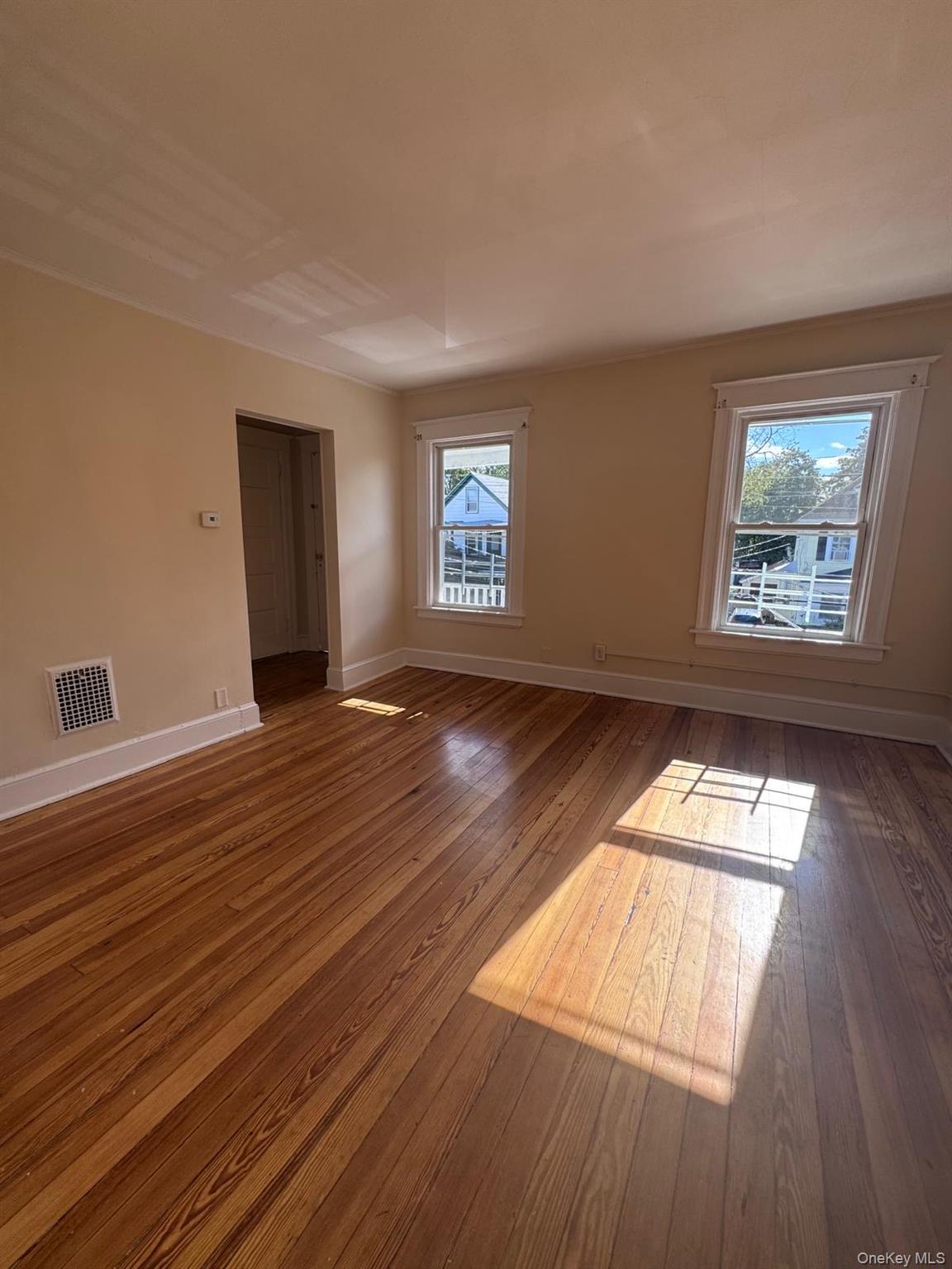 25 Lent Street, Unit 2 Poughkeepsie, NY 12601 - Photo 5 of 14 an empty room with wooden floor and windows