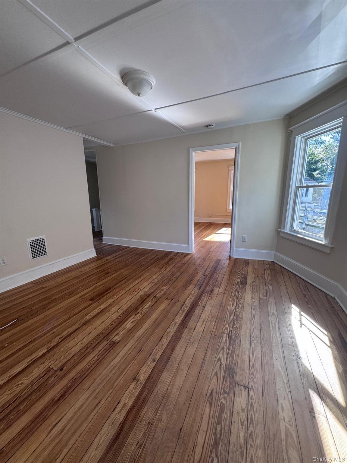 25 Lent Street, Unit 2 Poughkeepsie, NY 12601 - Photo 8 of 14 wooden floor in an empty room with a window