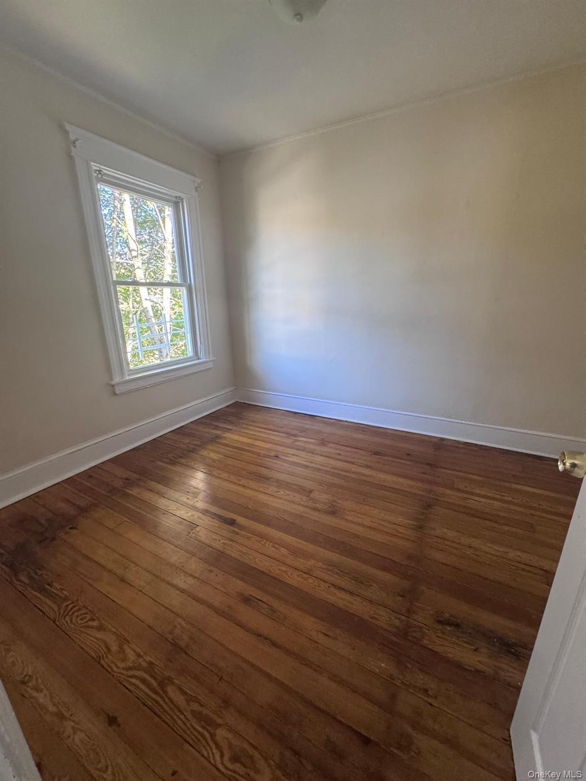 25 Lent Street, Unit 2 Poughkeepsie, NY 12601 - Photo 9 of 14 a view of an empty room with wooden floor and a window