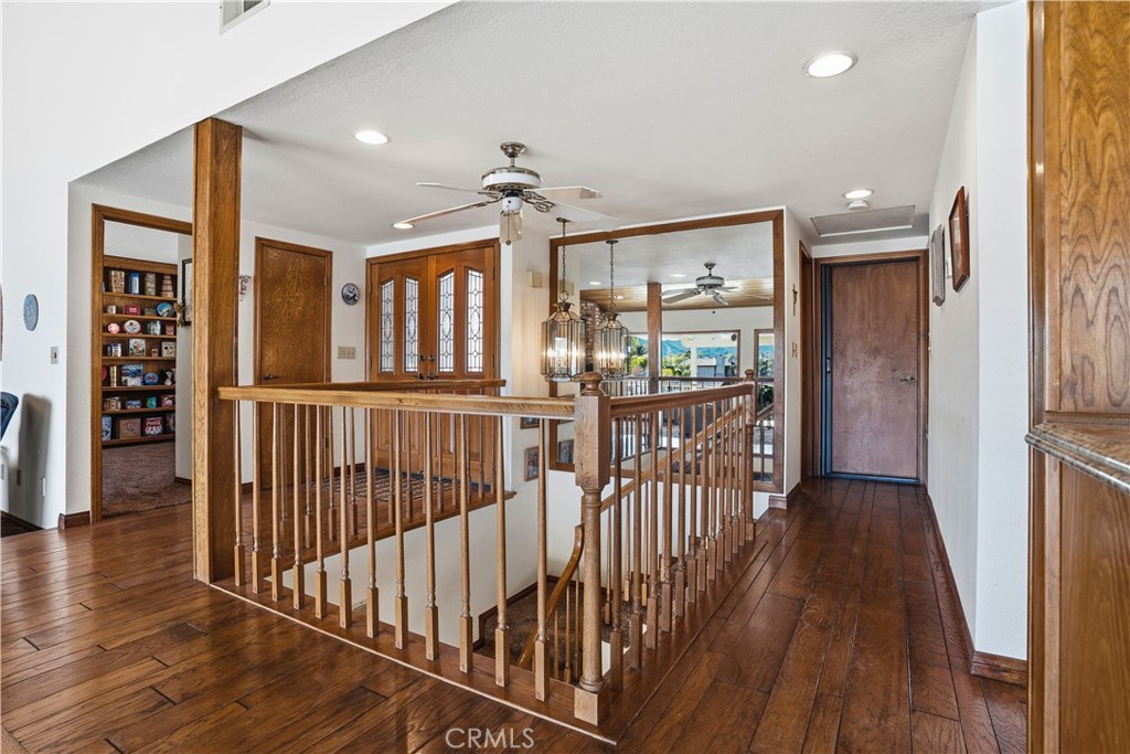30026 Big Range Road Canyon Lake, CA 92587 - Photo 11 of 48 a view of a hallway with wooden floor and windows