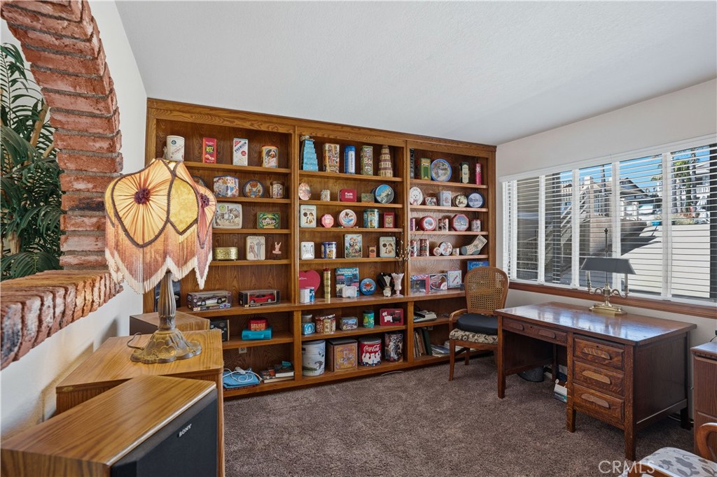 30026 Big Range Road Canyon Lake, CA 92587 - Photo 13 of 48 a living room with furniture a flat screen tv and a bookshelf