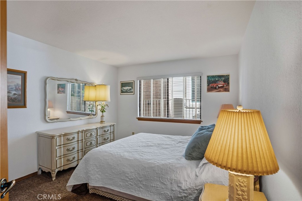 30026 Big Range Road Canyon Lake, CA 92587 - Photo 19 of 48 a bedroom with a bed and wooden floor