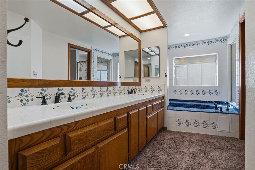 30026 Big Range Road Canyon Lake, CA 92587 - Photo 22 of 48 a bathroom with a sink and a large mirror