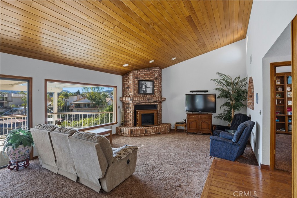 30026 Big Range Road Canyon Lake, CA 92587 - Photo 6 of 48 a living room with furniture a fireplace and a flat screen tv