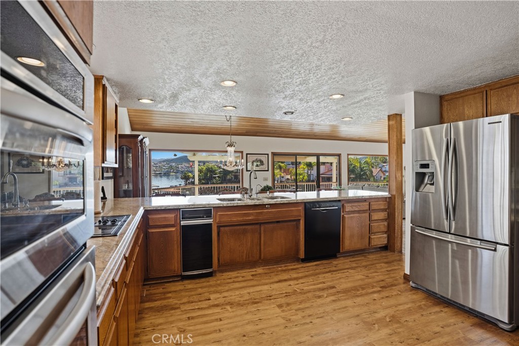 30026 Big Range Road Canyon Lake, CA 92587 - Photo 9 of 48 a large kitchen with stainless steel appliances granite countertop a large stove a refrigerator and a stove