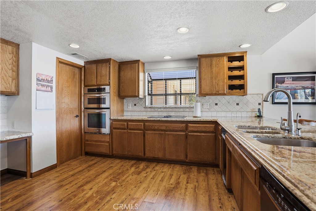 30026 Big Range Road Canyon Lake, CA 92587 - Photo 10 of 48 a kitchen with stainless steel appliances granite countertop a sink stove and refrigerator