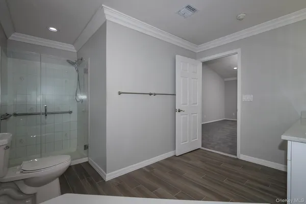 a bathroom with a toilet and a shower