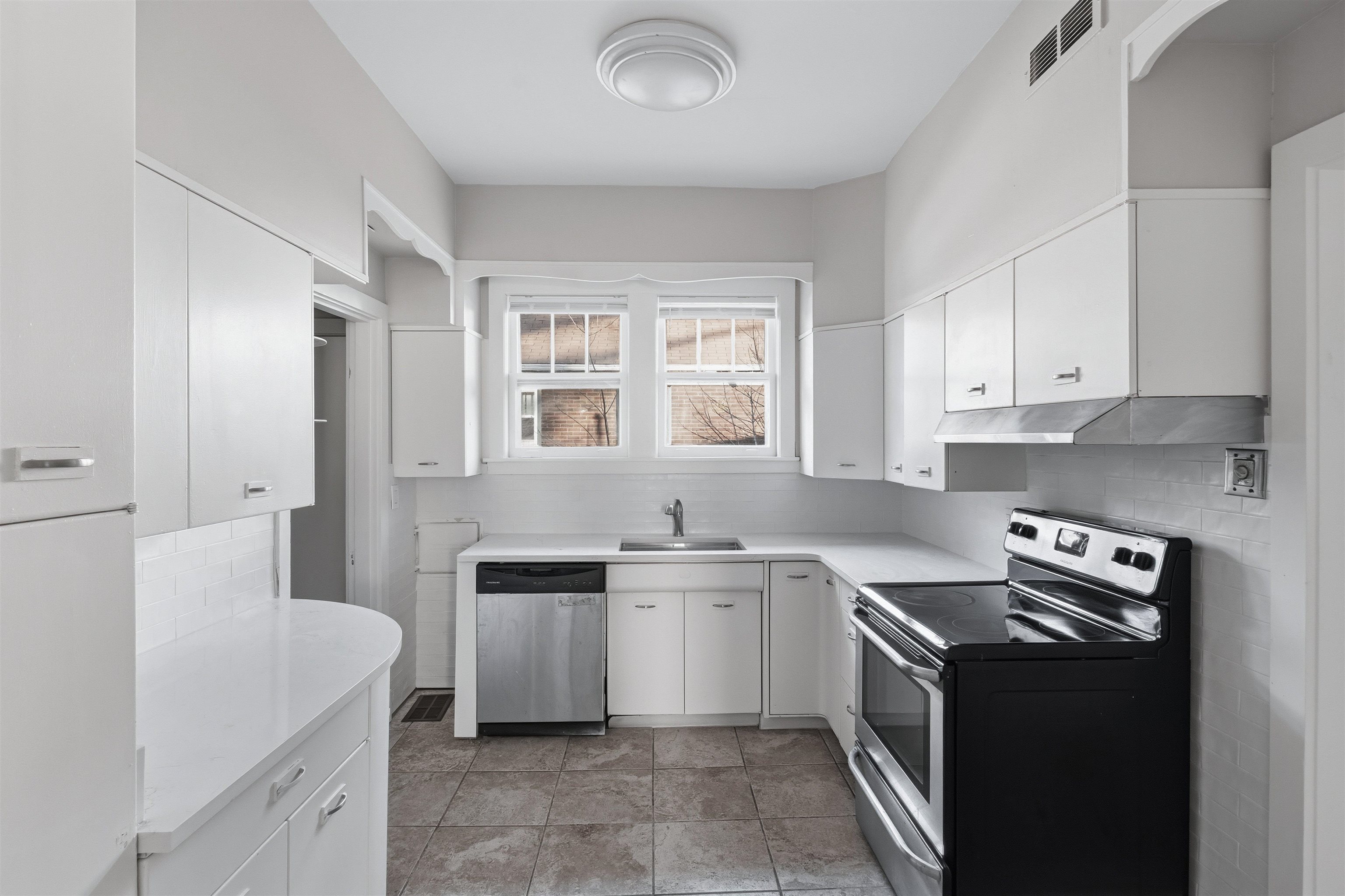 871 University Street Memphis, TN 38107 - Photo 12 of 26 a kitchen with a sink stove and cabinets