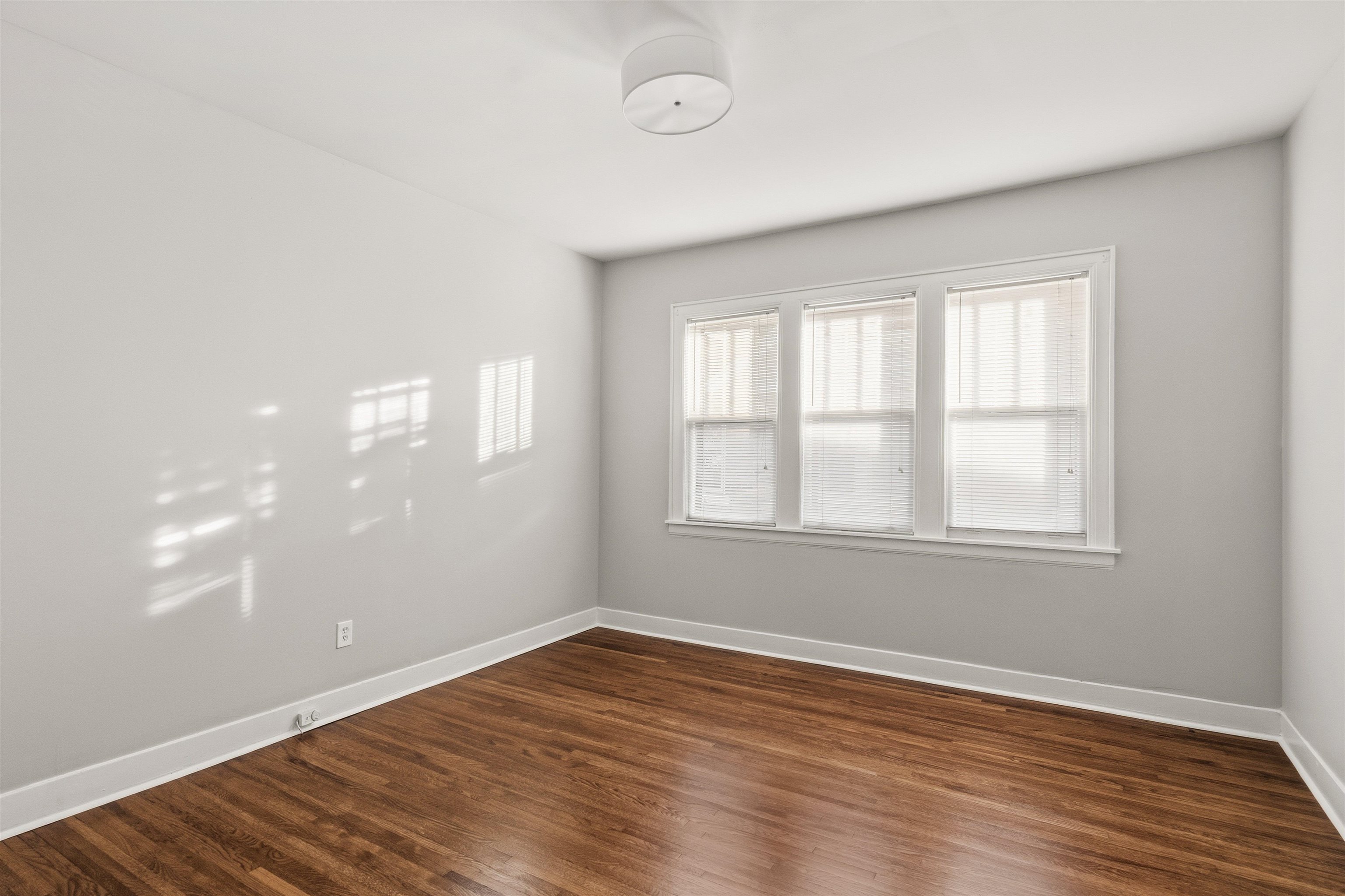 871 University Street Memphis, TN 38107 - Photo 14 of 26 an empty room with wooden floor and windows
