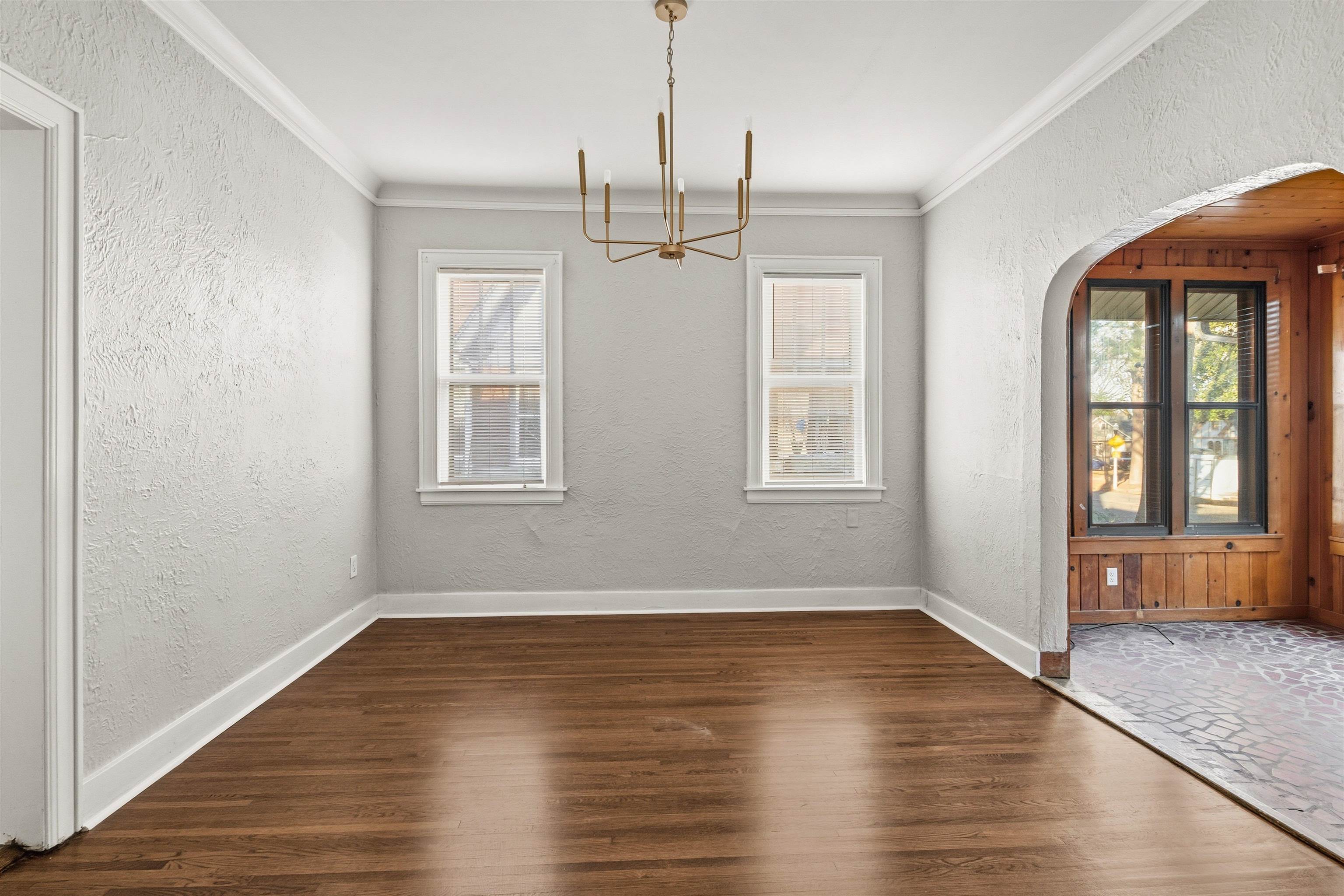 871 University Street Memphis, TN 38107 - Photo 7 of 26 a view of an empty room with wooden floor and a window