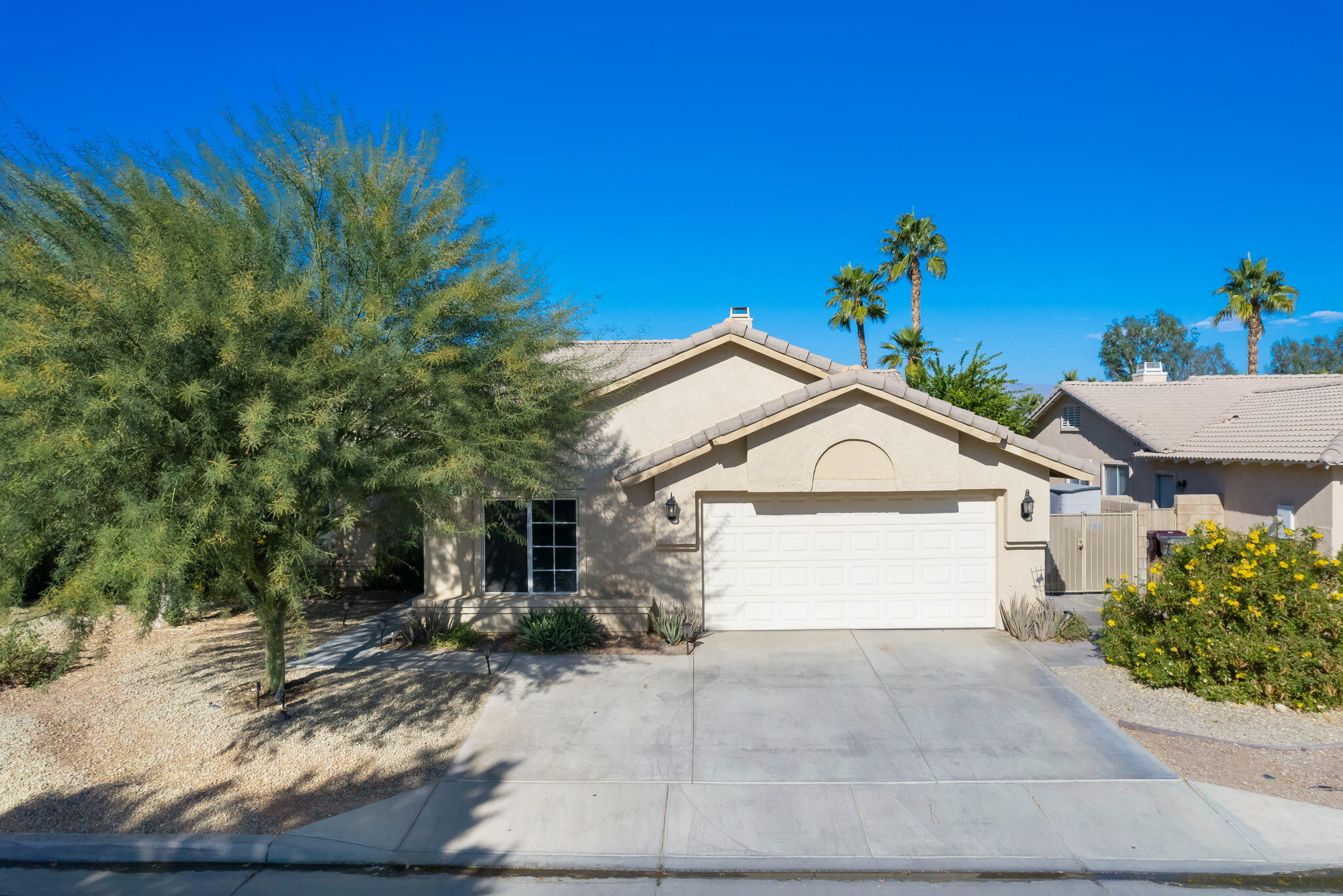 79350 Paseo Del Rey La Quinta, CA 92253 - Photo 1 of 41 a front view of a house with a yard and garage