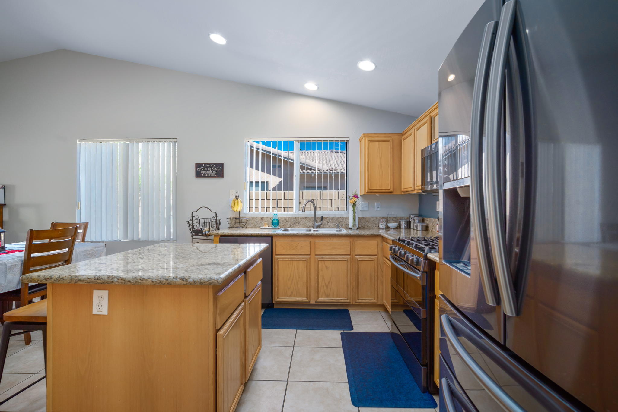 79350 Paseo Del Rey La Quinta, CA 92253 - Photo 12 of 41 a kitchen with stainless steel appliances granite countertop a sink stove and refrigerator