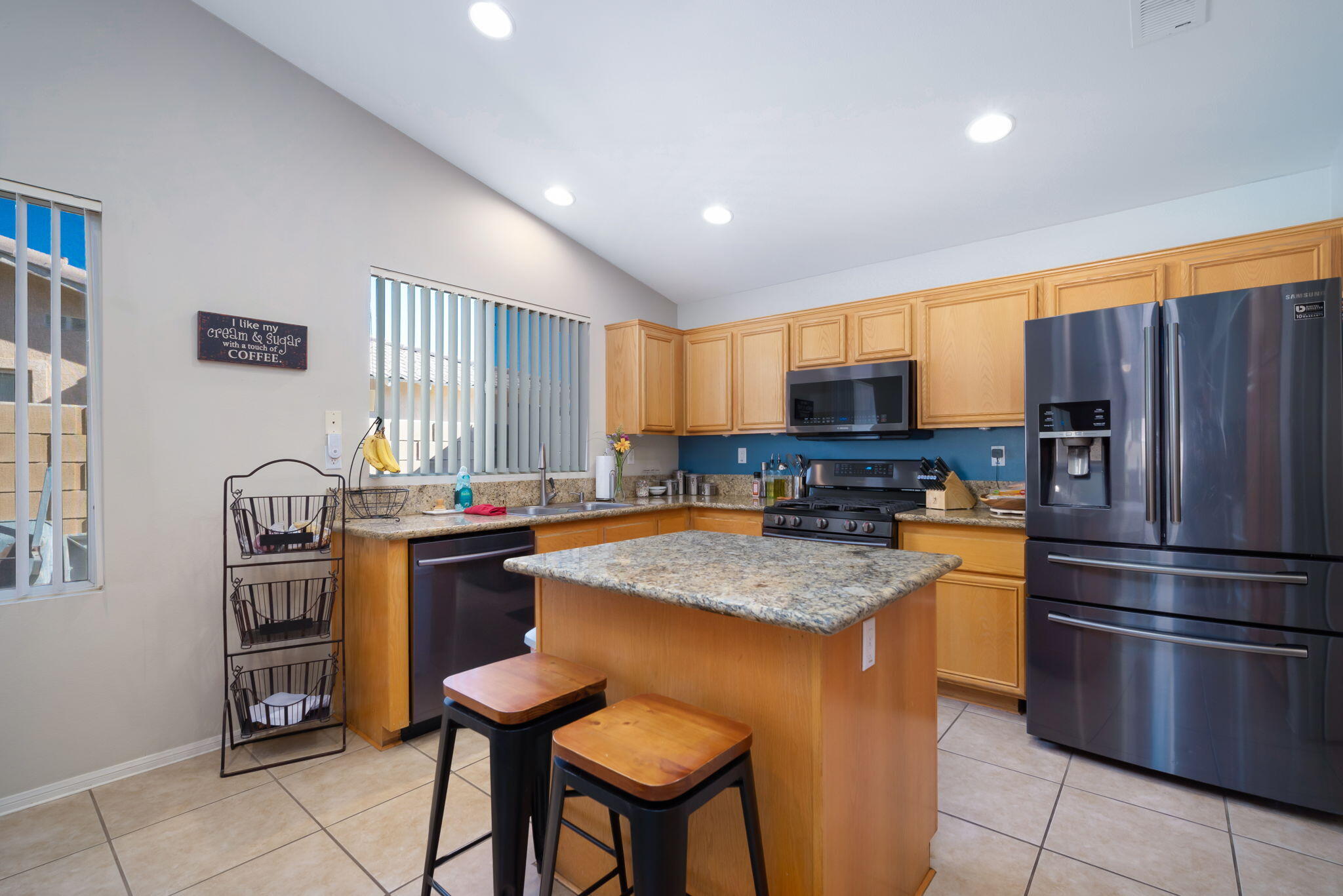 79350 Paseo Del Rey La Quinta, CA 92253 - Photo 13 of 41 a kitchen with stainless steel appliances granite countertop a stove refrigerator sink and cabinets