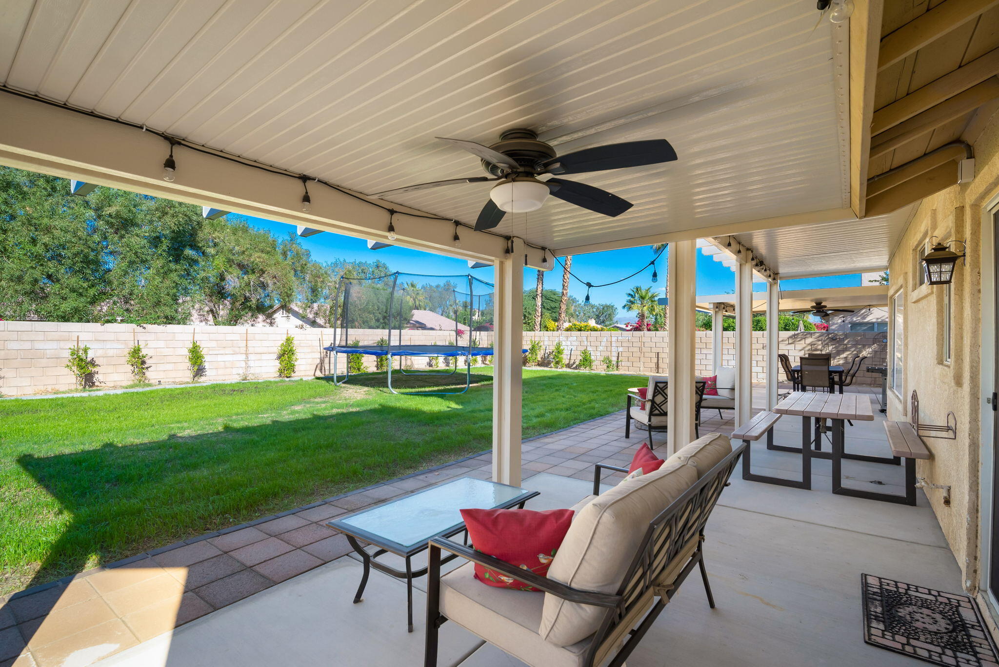 79350 Paseo Del Rey La Quinta, CA 92253 - Photo 35 of 41 a view of a patio with a table chairs and a backyard