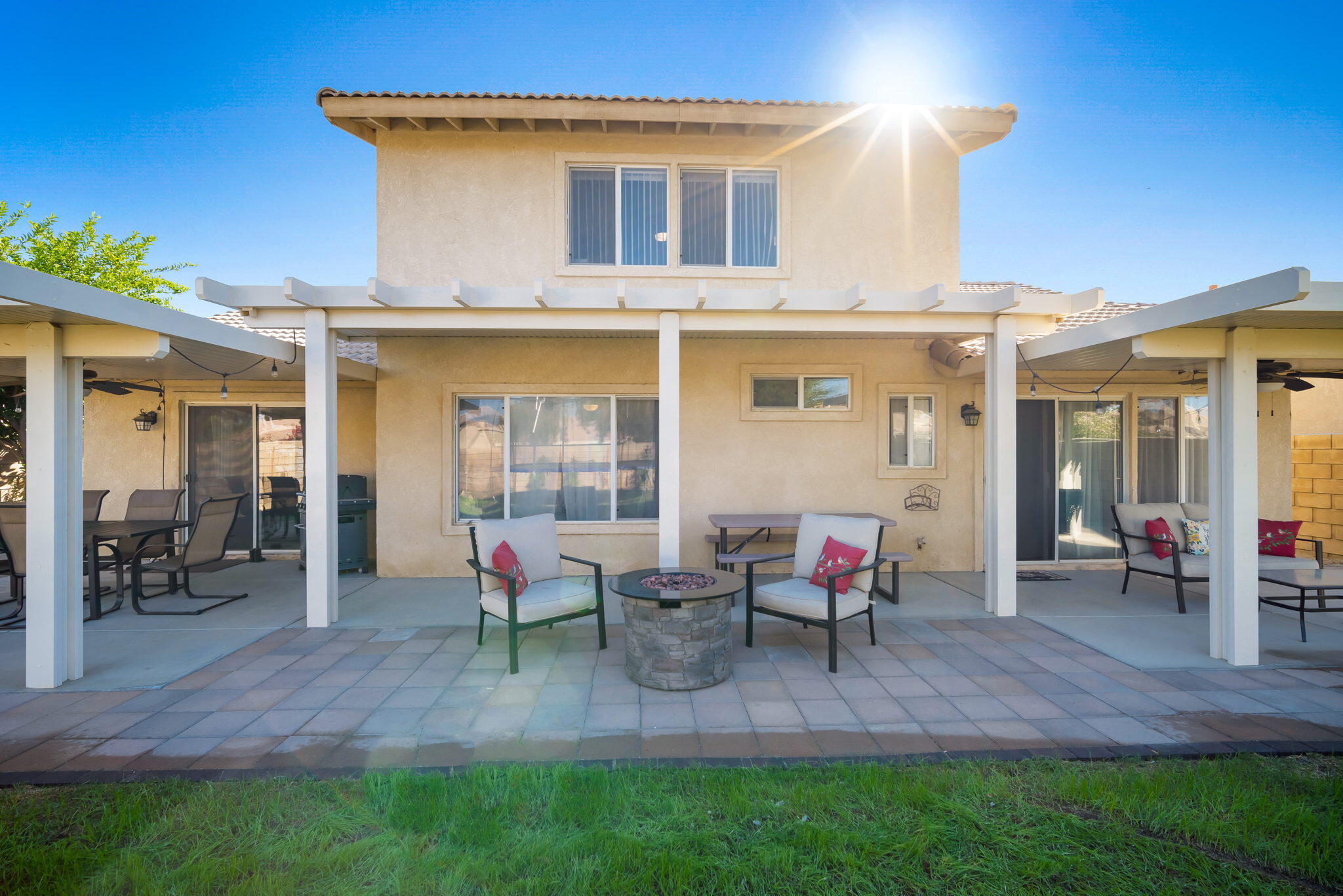 79350 Paseo Del Rey La Quinta, CA 92253 - Photo 36 of 41 a backyard of a house with table chairs and a yard