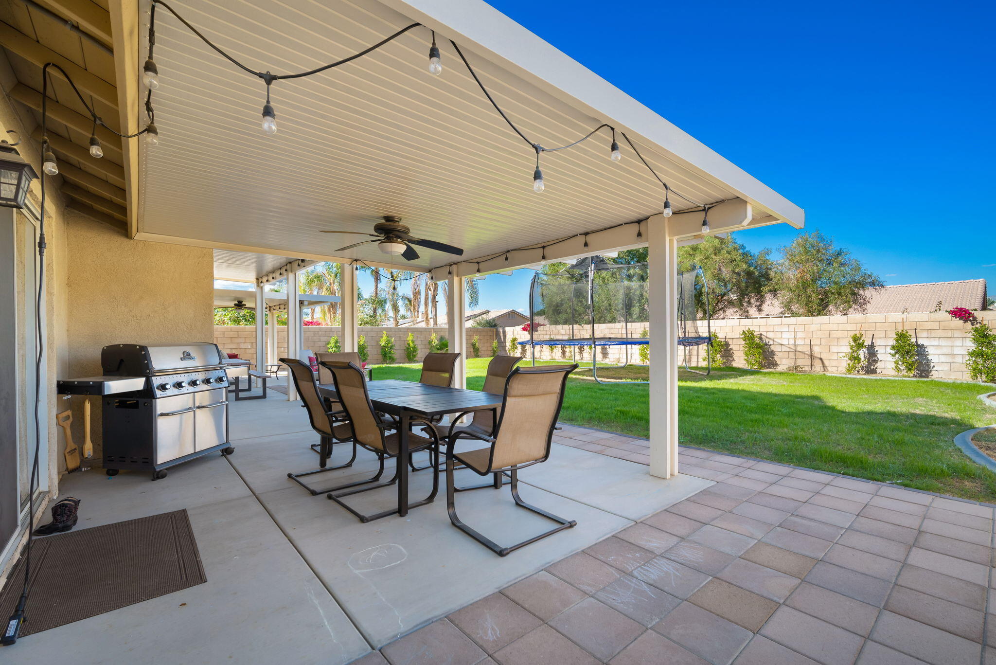 79350 Paseo Del Rey La Quinta, CA 92253 - Photo 37 of 41 a view of a patio with a table chairs and a backyard