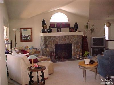 144 Bryce Canyon Road, Unit 99999 San Rafael, CA 94903 - Photo 2 of 7 a living room with furniture and a fireplace