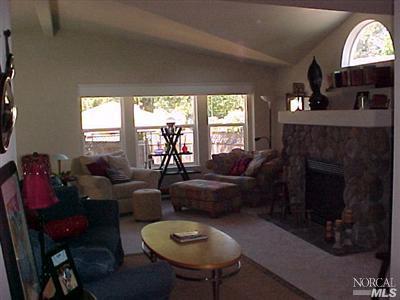 144 Bryce Canyon Road, Unit 99999 San Rafael, CA 94903 - Photo 3 of 7 a living room with furniture a fireplace and a large window