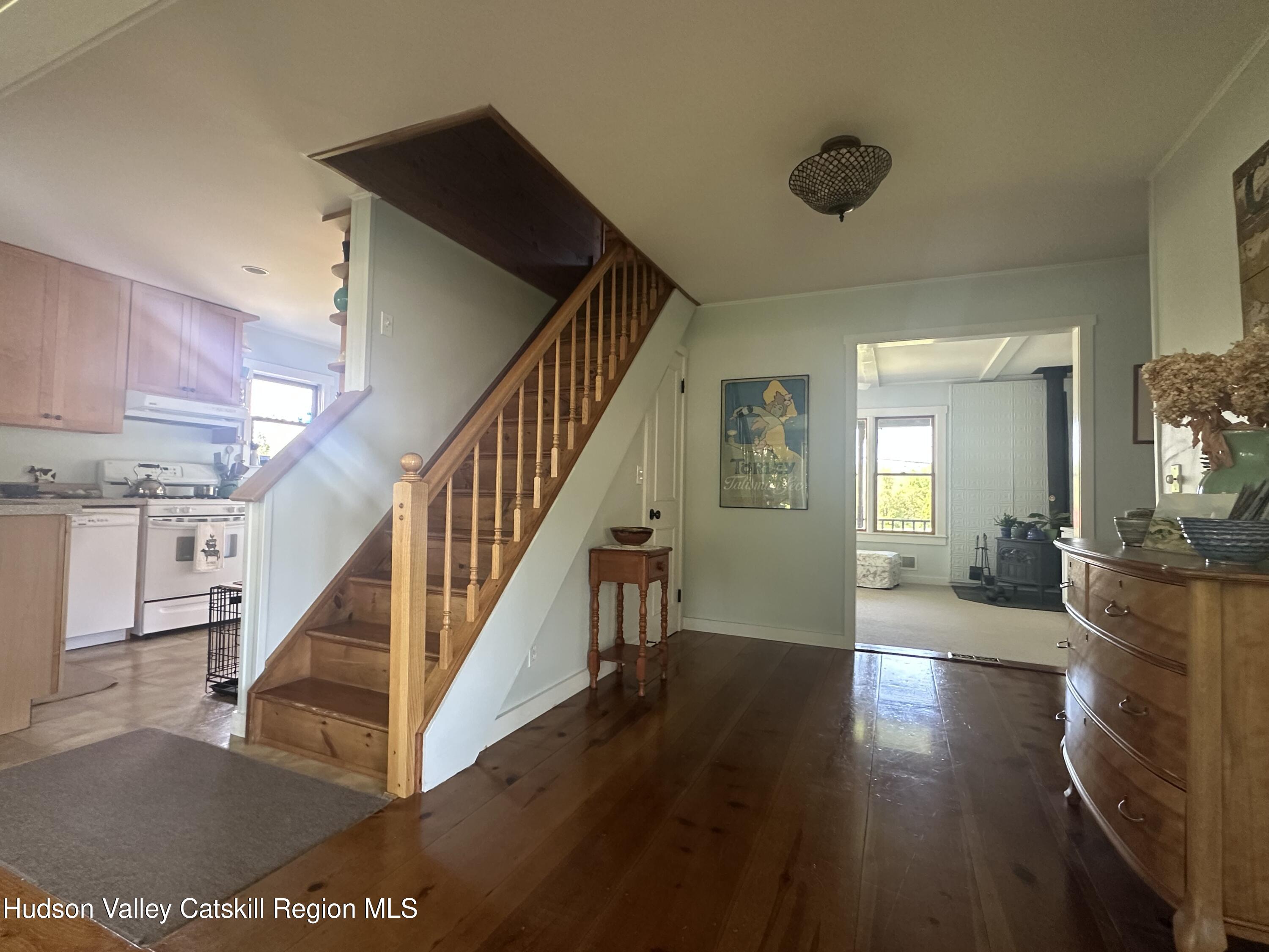 1492 County Road Copake, NY 12516 - Photo 6 of 34 a view of a livingroom with wooden floor and stairs
