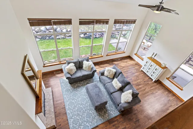 a living room with furniture a flat screen tv and a table