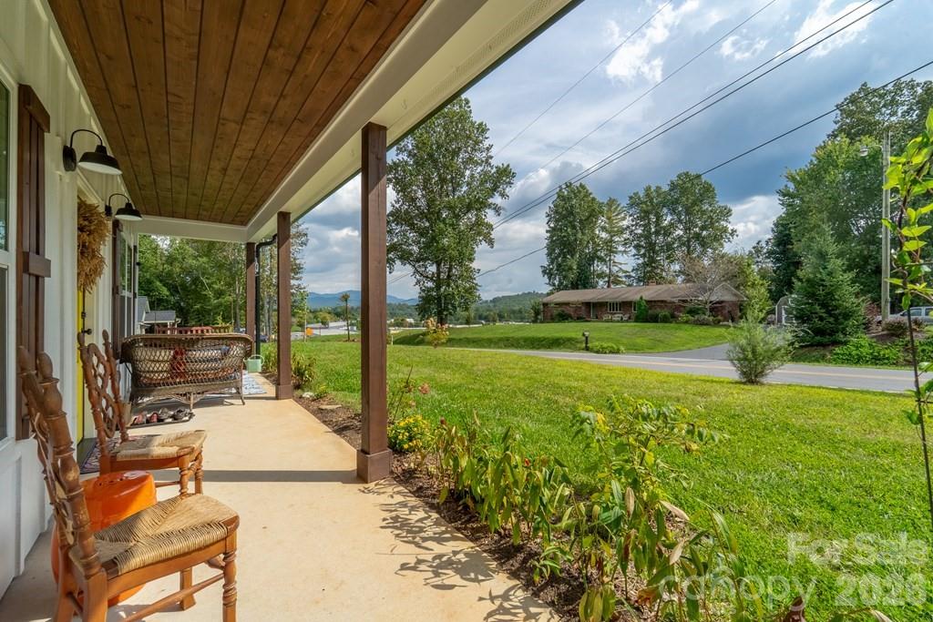 190 Fort Hembree Road Hayesville, NC 28904 - Photo 4 of 18 a view of a patio with table and chairs potted plants and floor to ceiling window