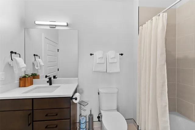 a bedroom with a bed and bathroom