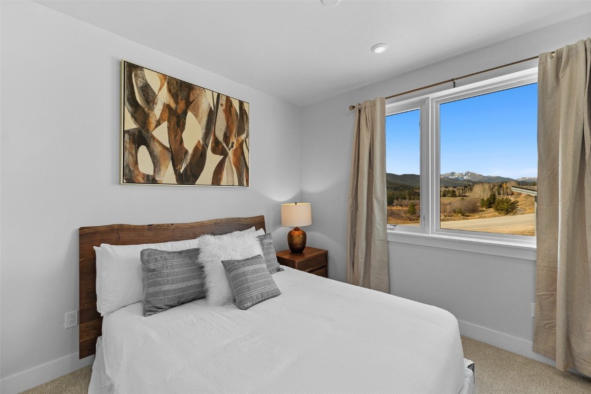 125 West Keystone Road, Unit 105 Keystone, CO 80435 - Photo 17 of 32 a bedroom with a bed and a painting on the wall