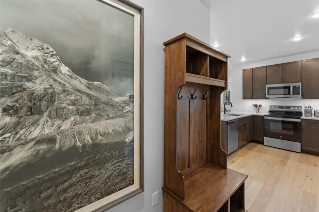 a kitchen with granite countertop a refrigerator and a stove top oven