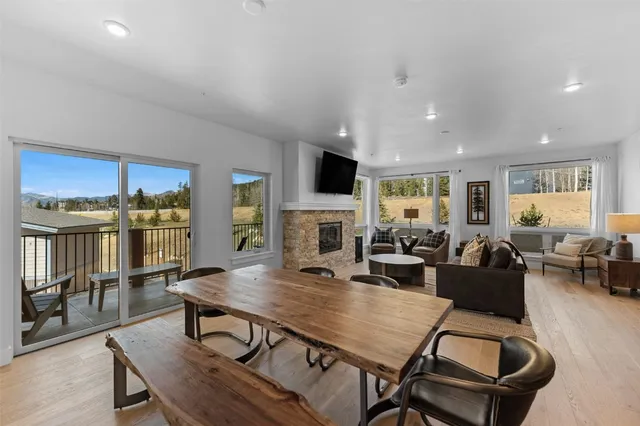 a living room with furniture flat screen tv and kitchen view