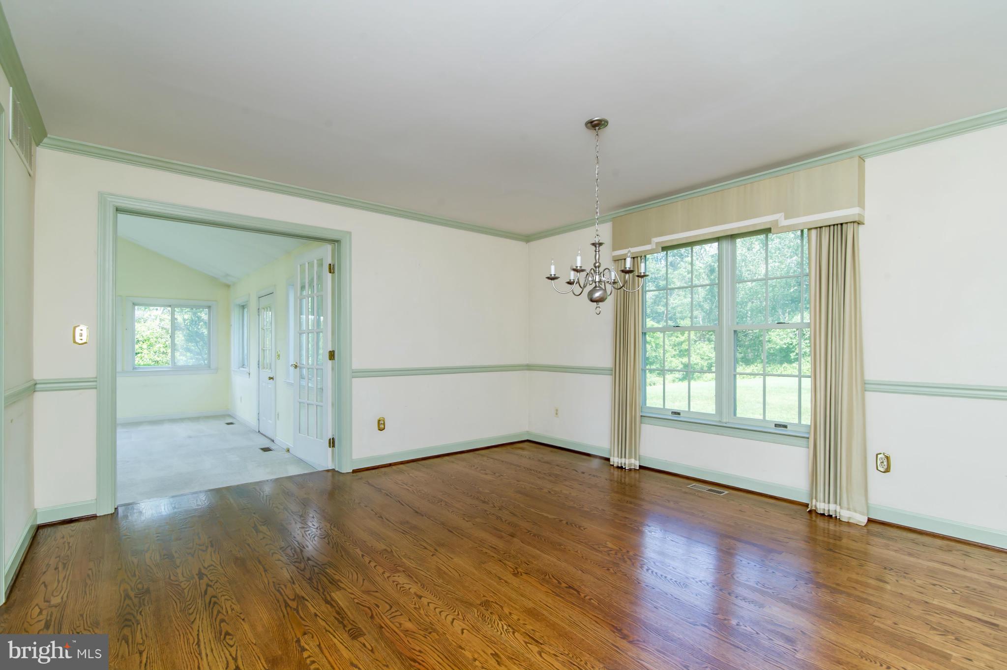 17615 Falls Road Upperco, MD 21155 - Photo 11 of 26 an empty room with wooden floor and windows