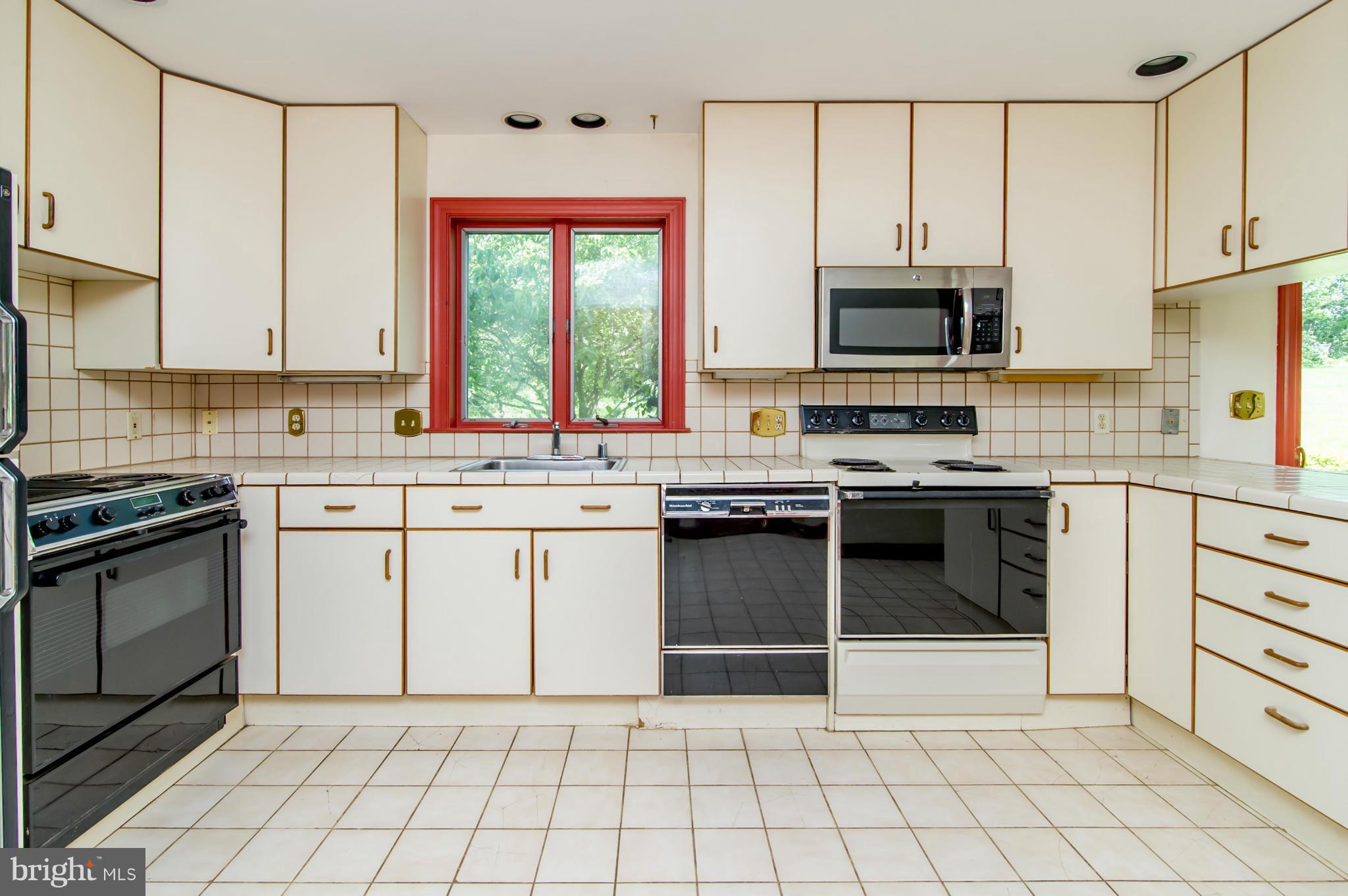 17615 Falls Road Upperco, MD 21155 - Photo 5 of 26 a kitchen with a stove a sink and a microwave