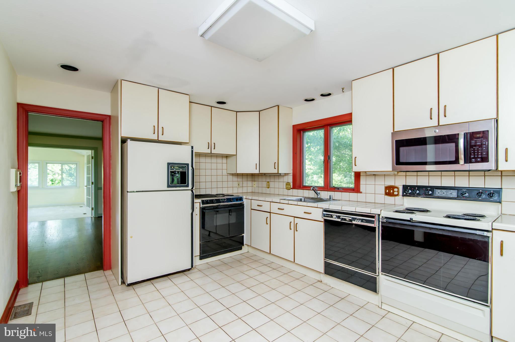 17615 Falls Road Upperco, MD 21155 - Photo 6 of 26 a kitchen with stainless steel appliances granite countertop a stove a sink and a refrigerator
