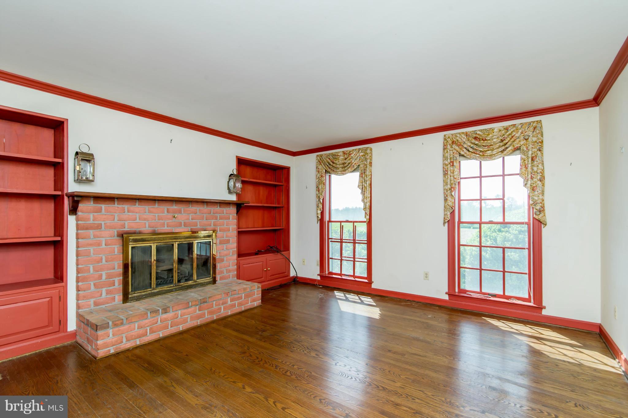 17615 Falls Road Upperco, MD 21155 - Photo 7 of 26 a view of an empty room with window and fire place