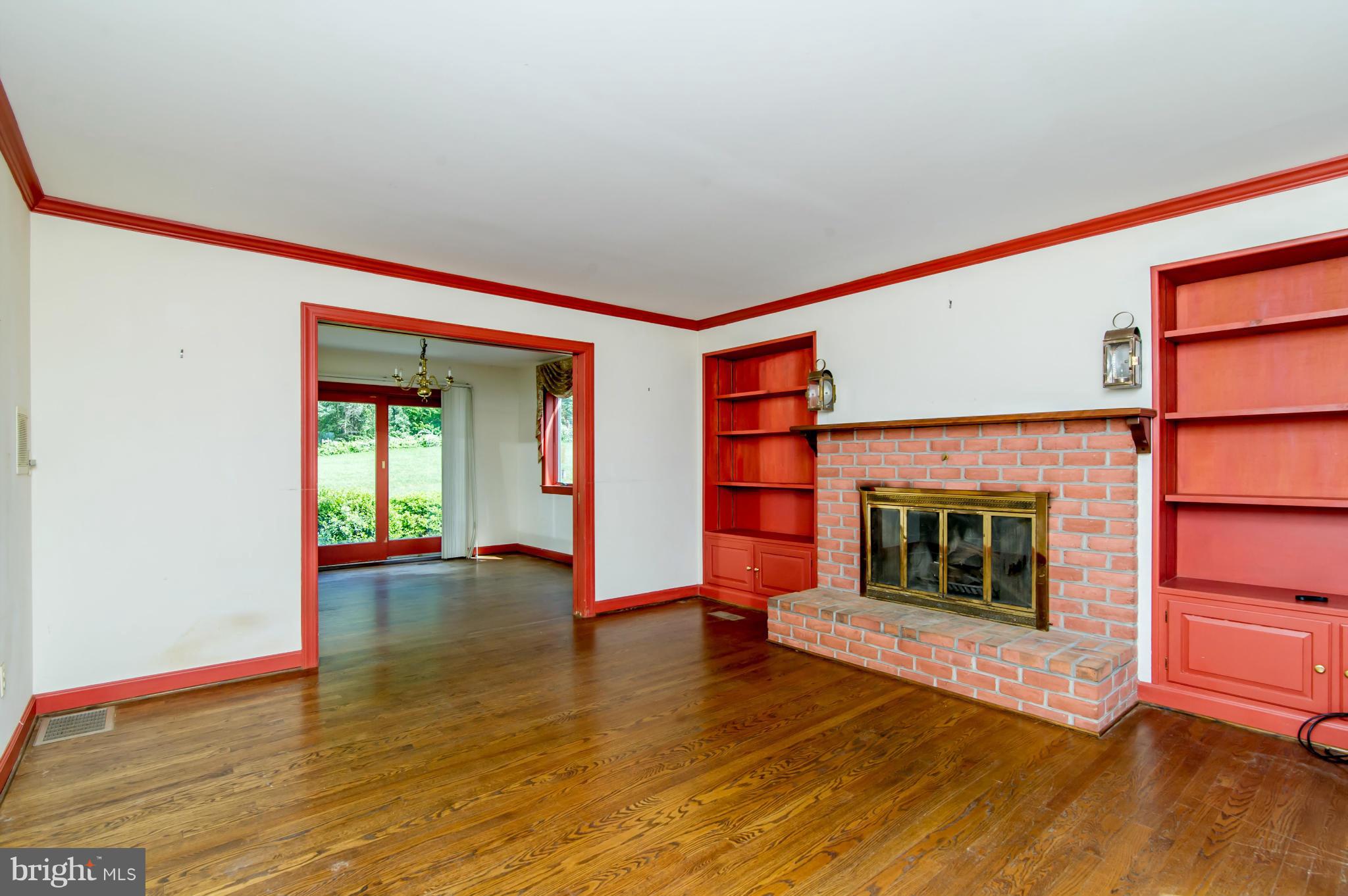17615 Falls Road Upperco, MD 21155 - Photo 8 of 26 wooden floor fireplace and windows in an empty room