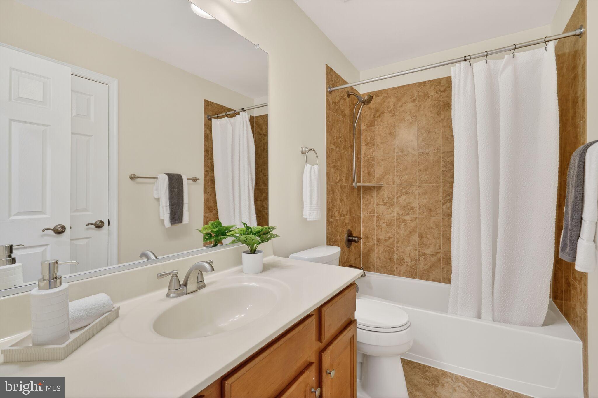 9144 Furey Road Lorton, VA 22079 - Photo 20 of 28 a bathroom with a granite countertop sink toilet and shower