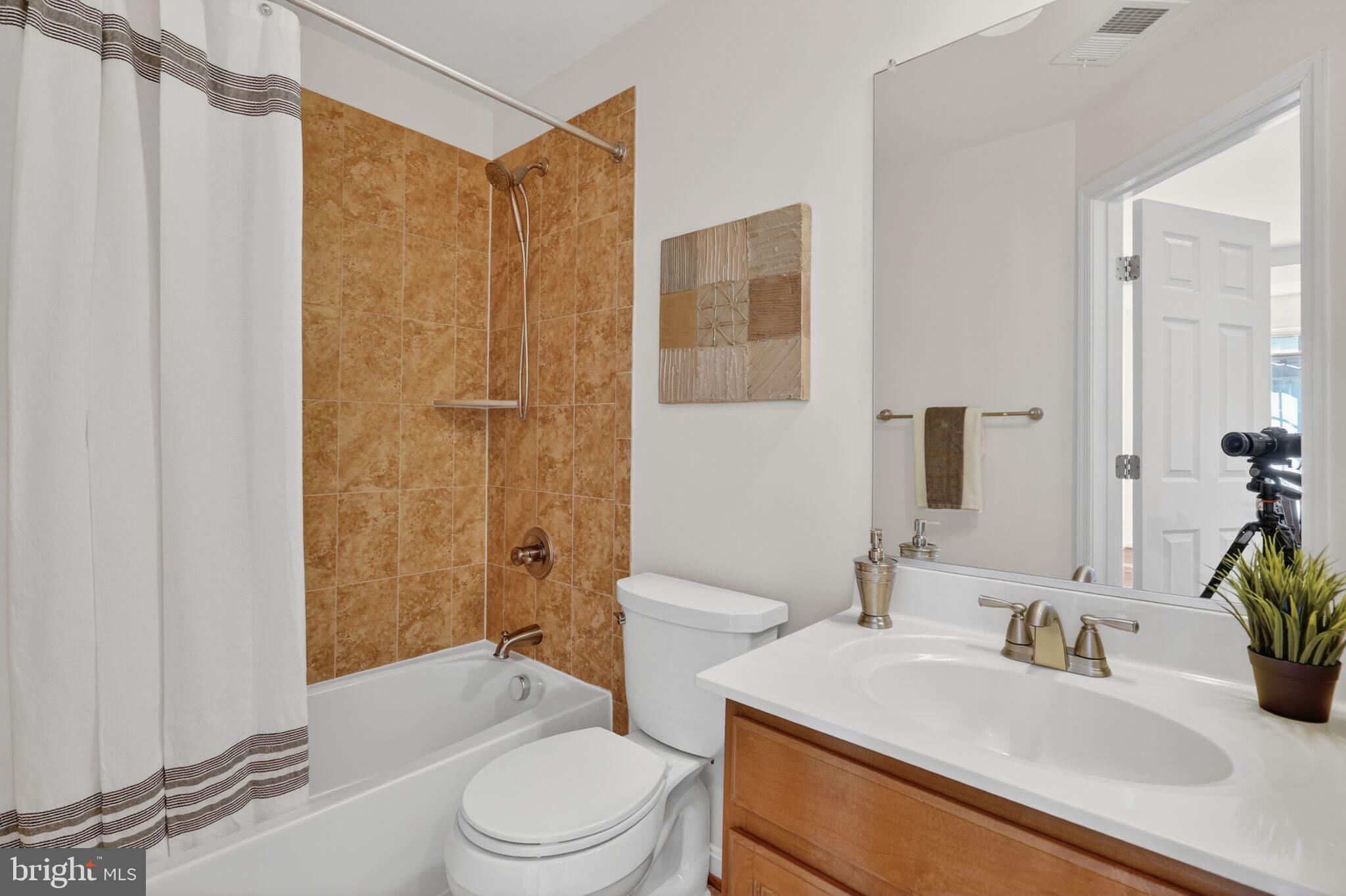 9144 Furey Road Lorton, VA 22079 - Photo 27 of 28 a bathroom with a sink toilet and shower