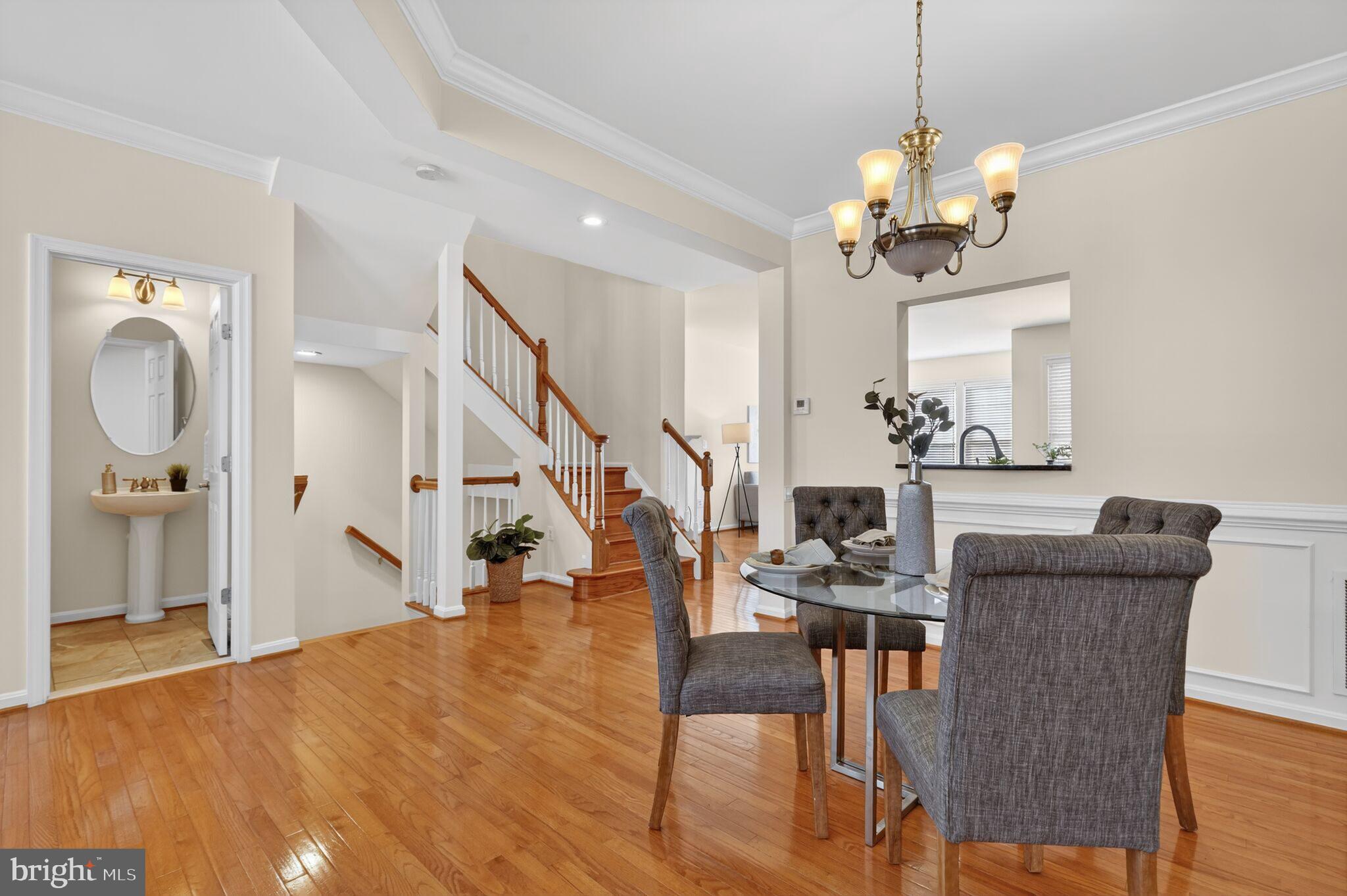 9144 Furey Road Lorton, VA 22079 - Photo 5 of 28 a view of a livingroom and a dining room with wooden floor a chandelier