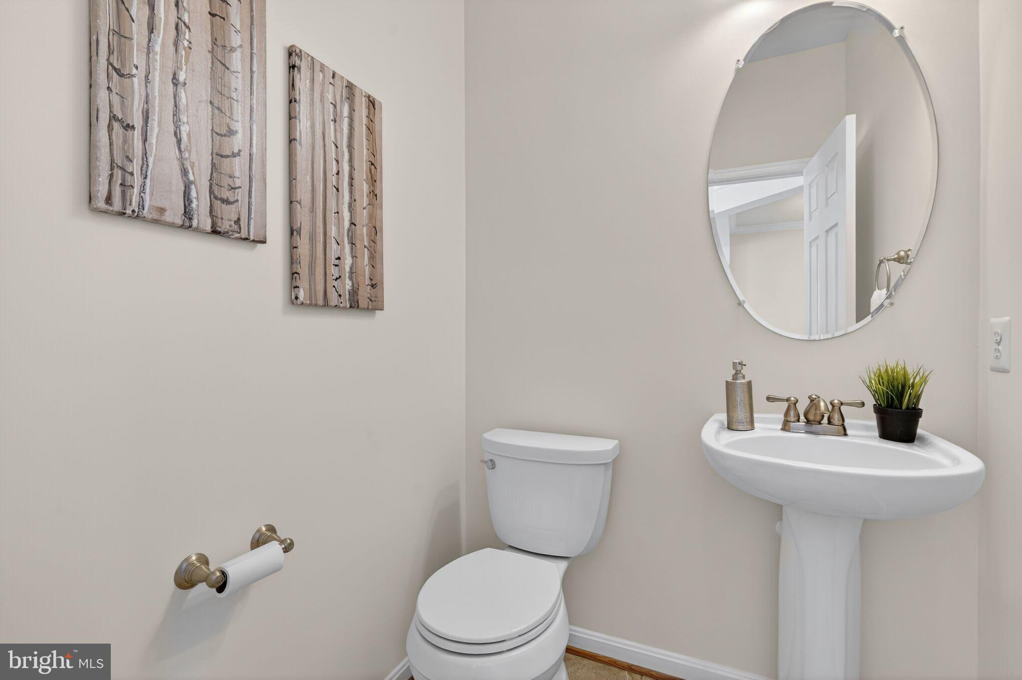 9144 Furey Road Lorton, VA 22079 - Photo 7 of 28 a bathroom with a toilet sink and mirror