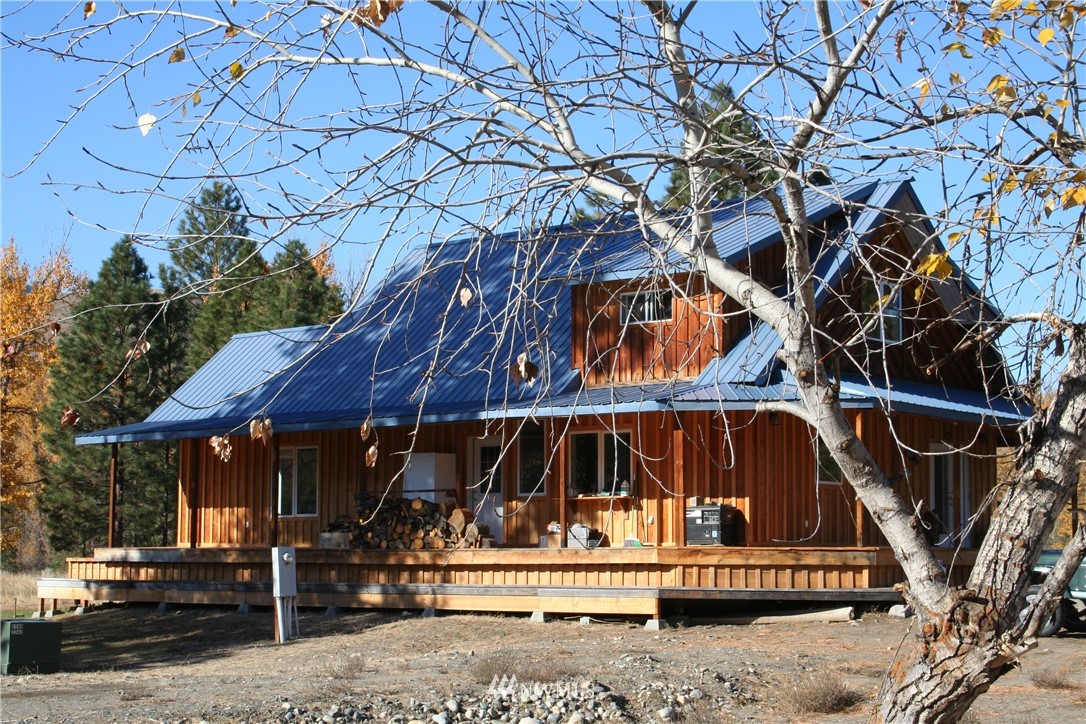 46 Beaver Pond Road Twisp, WA 98856 - Photo 1 of 31 a view of small house with wooden fence