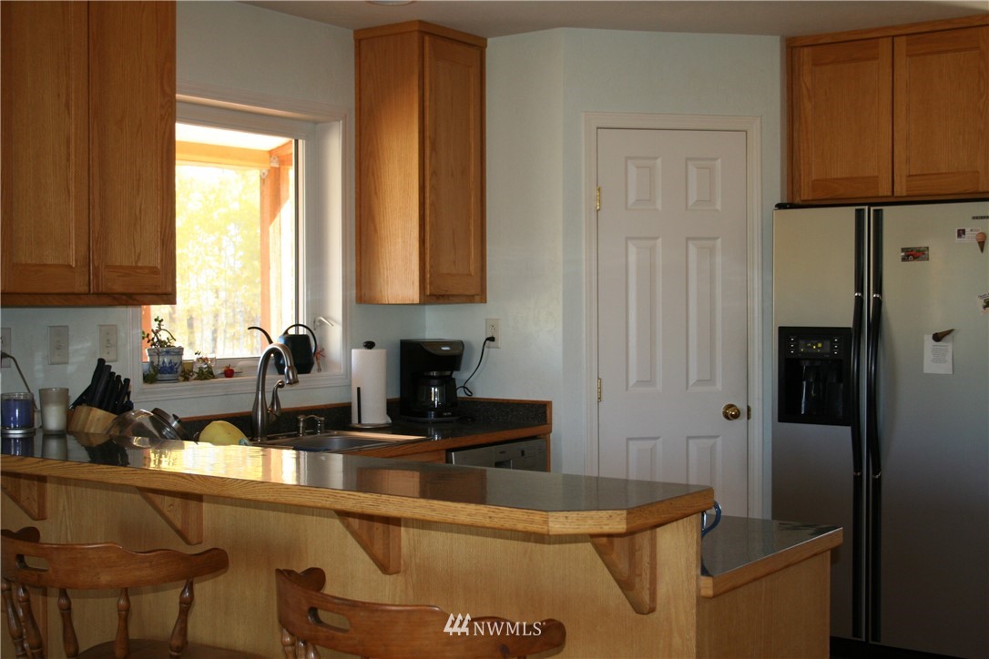 46 Beaver Pond Road Twisp, WA 98856 - Photo 15 of 31 a kitchen with a sink a refrigerator and cabinets