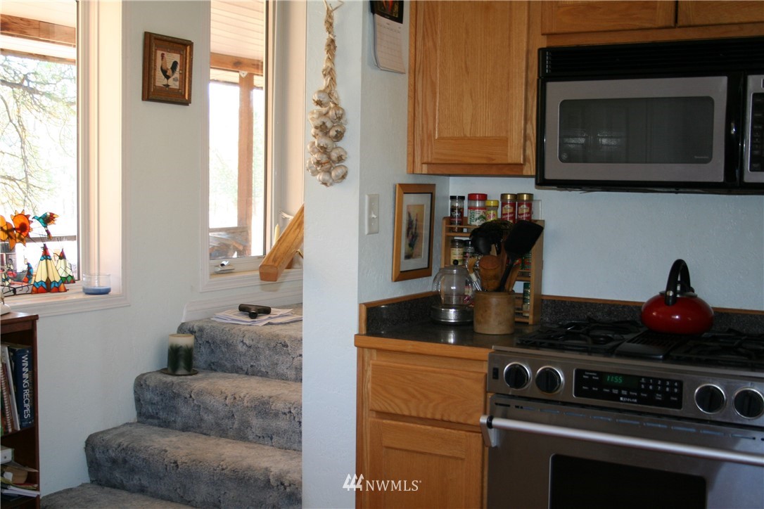 46 Beaver Pond Road Twisp, WA 98856 - Photo 22 of 31 a kitchen with stainless steel appliances granite countertop a stove and a microwave