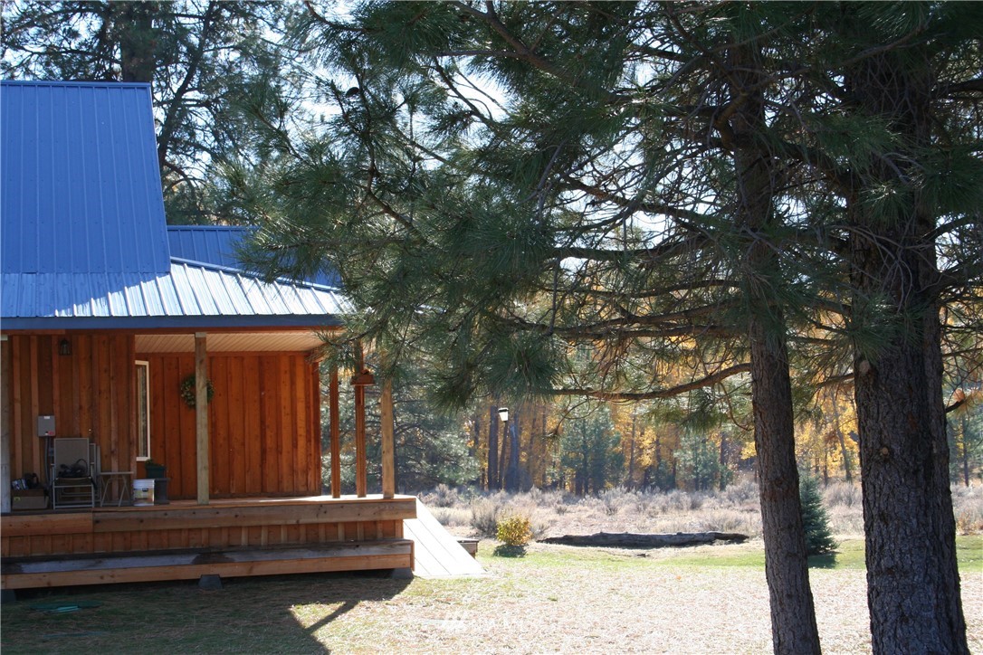 46 Beaver Pond Road Twisp, WA 98856 - Photo 10 of 31 a view of backyard with large tree and wooden fence