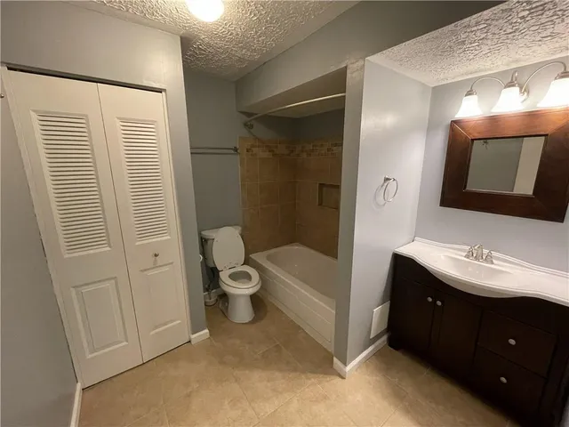 a bathroom with a double vanity sink toilet and shower