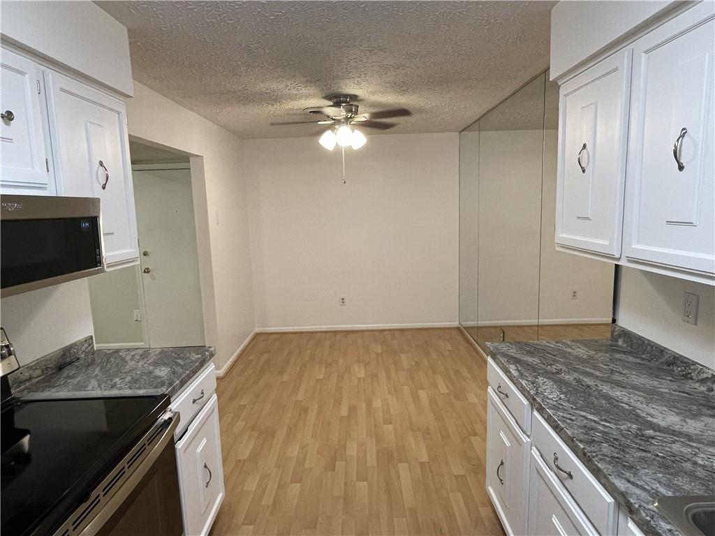 300 Gilkeson Road, Unit C7 Pittsburgh, PA 15228 - Photo 7 of 13 a kitchen with a stove and a granite counter tops